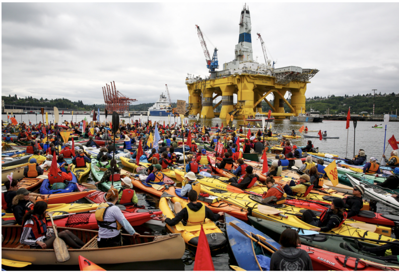 Kayaktivists swarming a drilling rig.